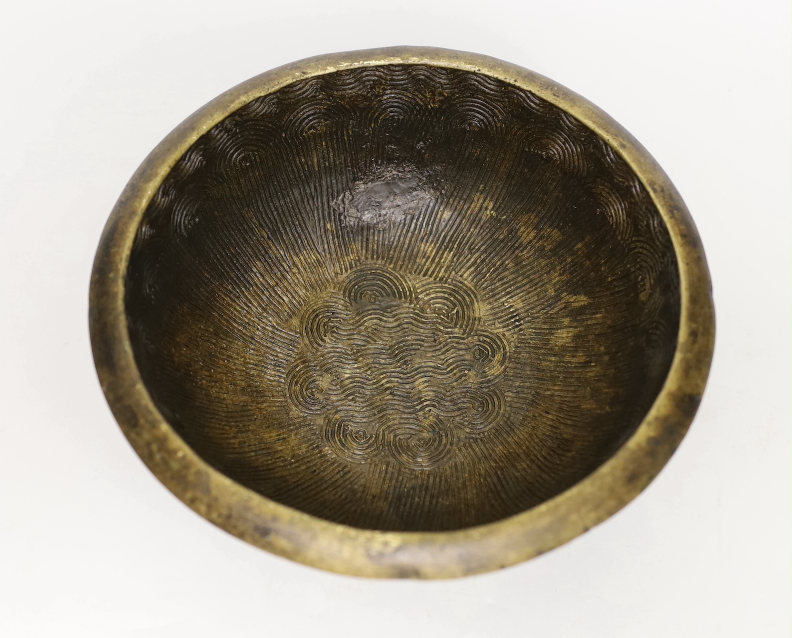 A Tibetan brass singing bowl, Lishui pattern, 23cm diameter